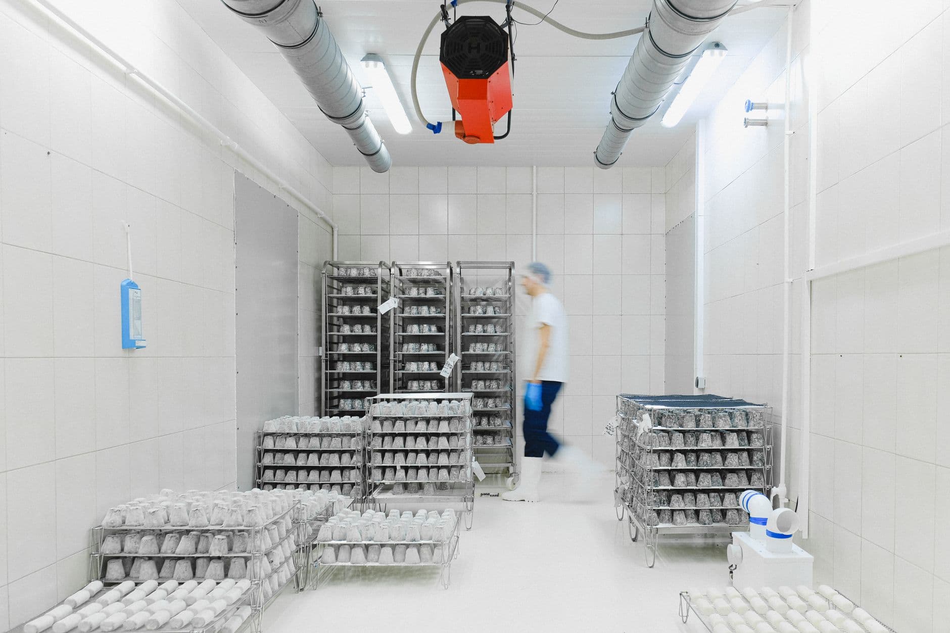 Cold storage warehouse interior with shelving and perishable goods, illustrating the commercial refrigeration sector subject to 40 CFR § 84.106 leak management obligations